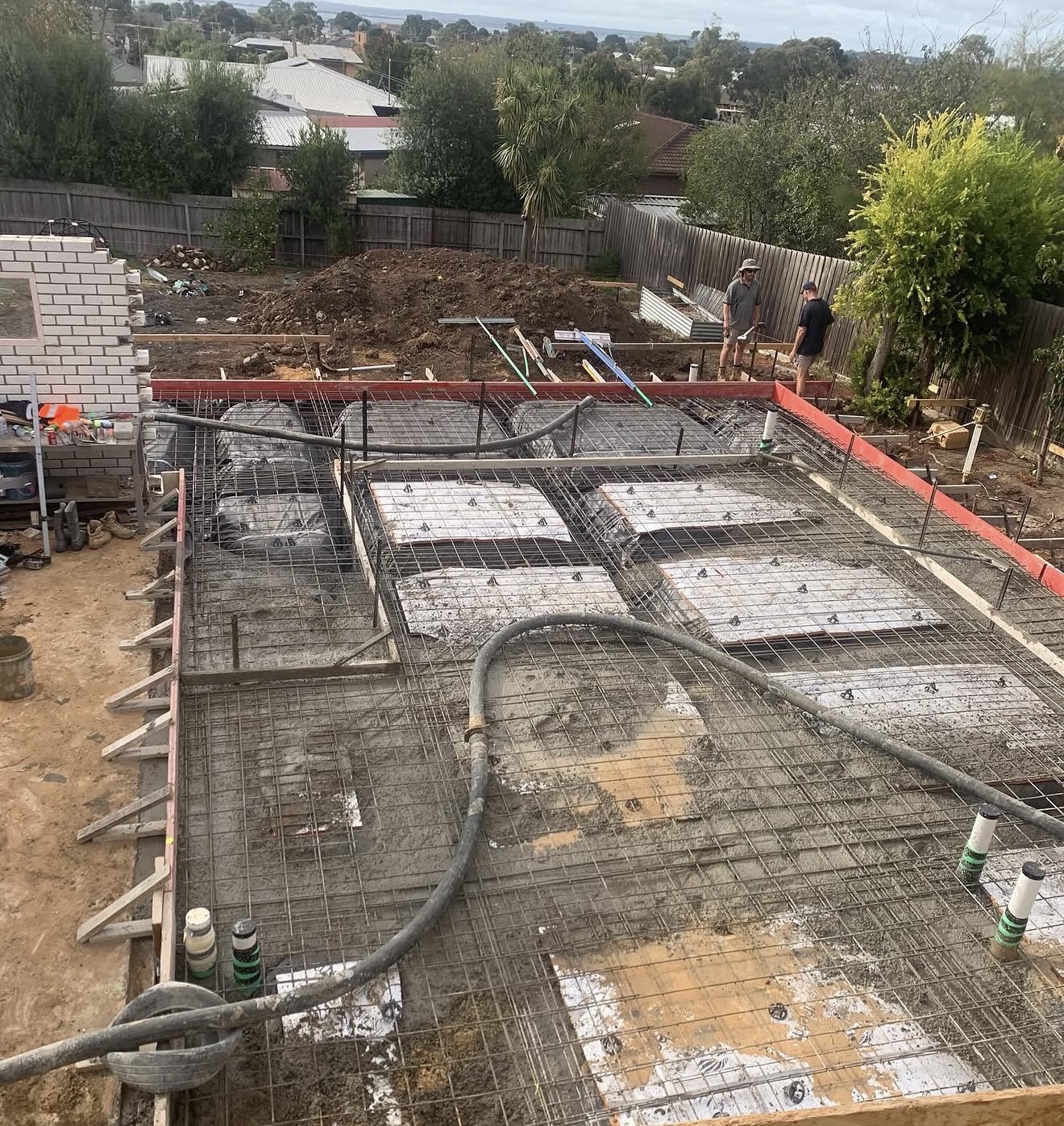 Residential slab pour with rebar and pump hose